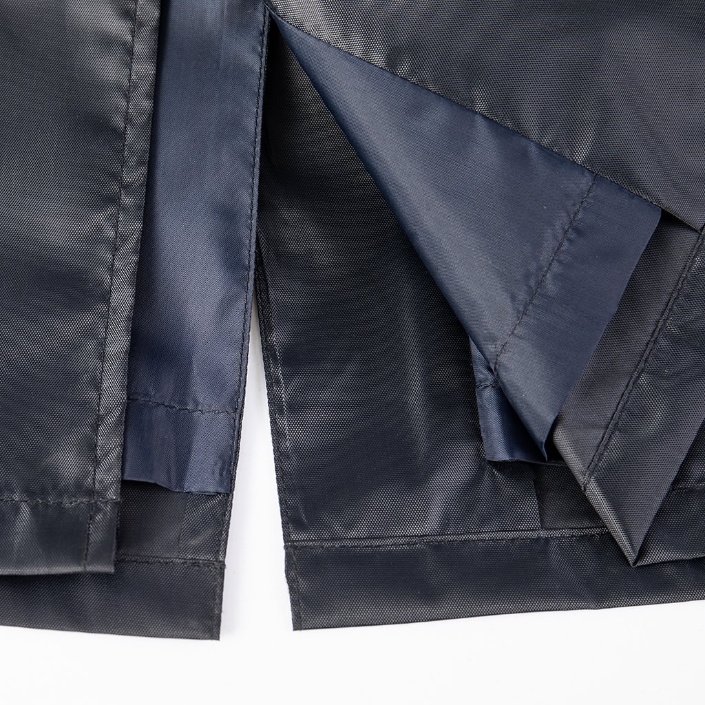 Close-up of the rear vent on the custom navy blue waterproof trench coat, showing the interior lining.