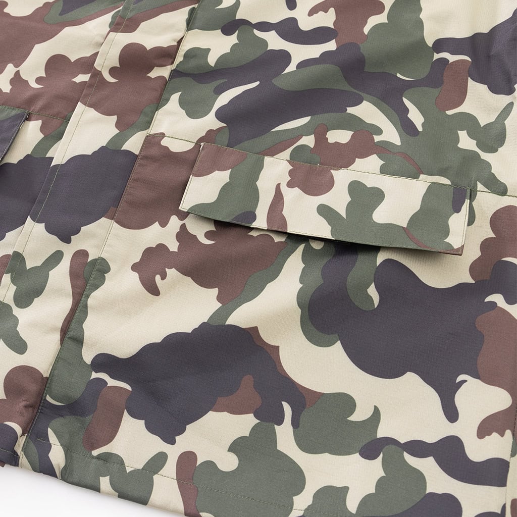 Close-up of the front zipper with a velcro storm flap on the custom woodland camo military rain poncho.
