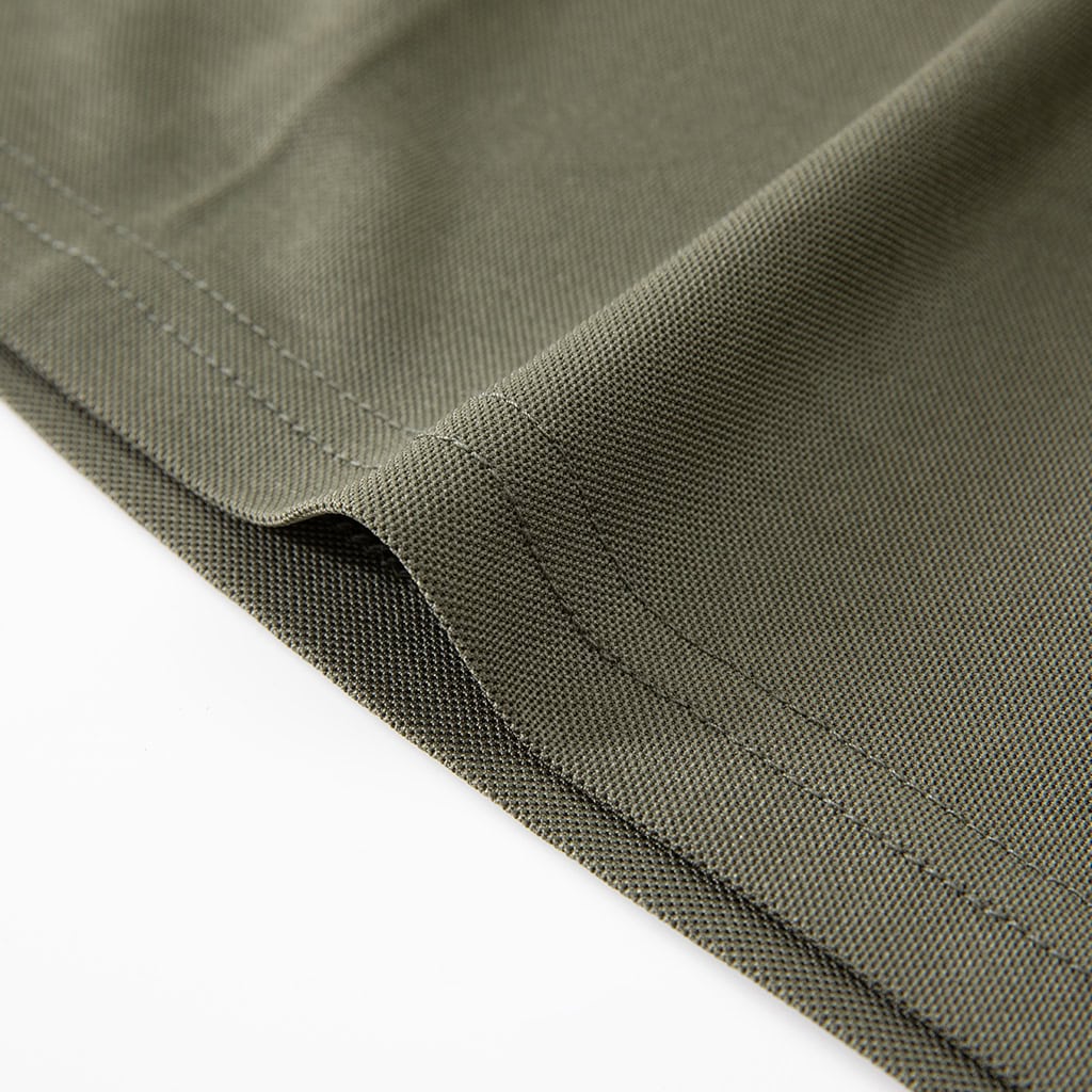Close-up of the durable, double-stitched hem on the custom olive green tactical polo shirt.