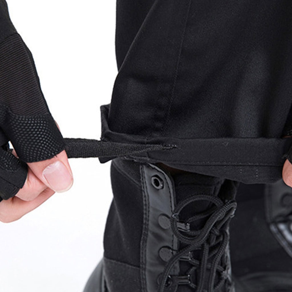Detail of the adjustable strap at the leg opening of the custom black security guard uniform trousers.