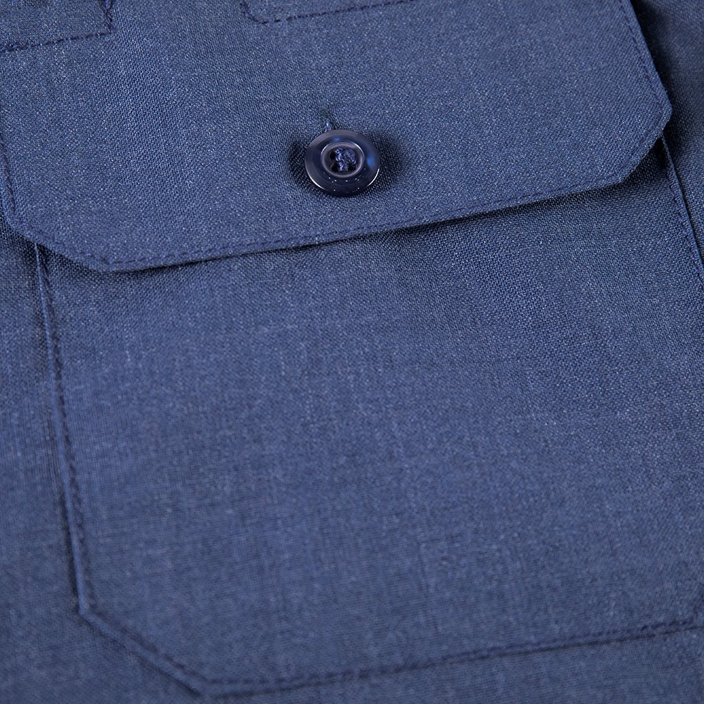 Close-up of the flapped chest pocket on the custom navy wool blend uniform shirt.