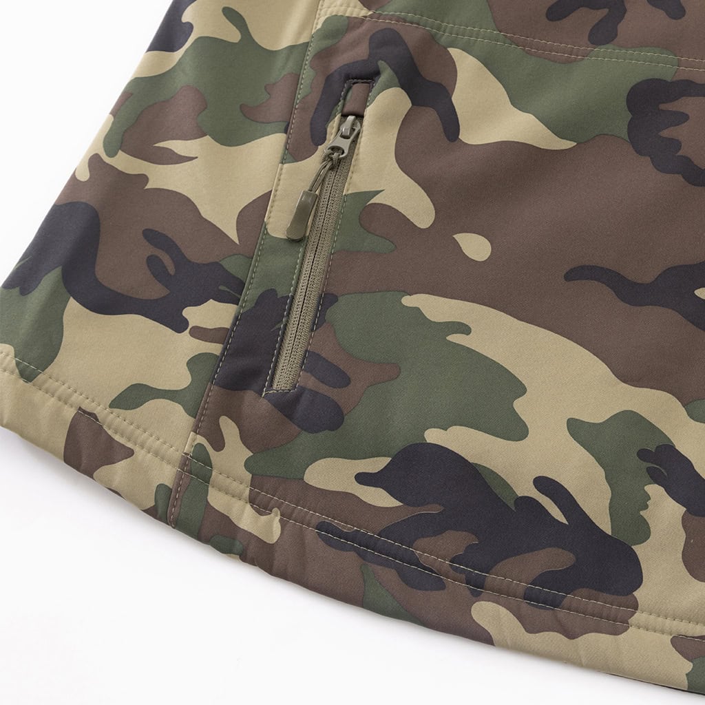 Close-up of the zippered arm pocket with velcro panel on the sleeve of the custom woodland camo softshell jacket.