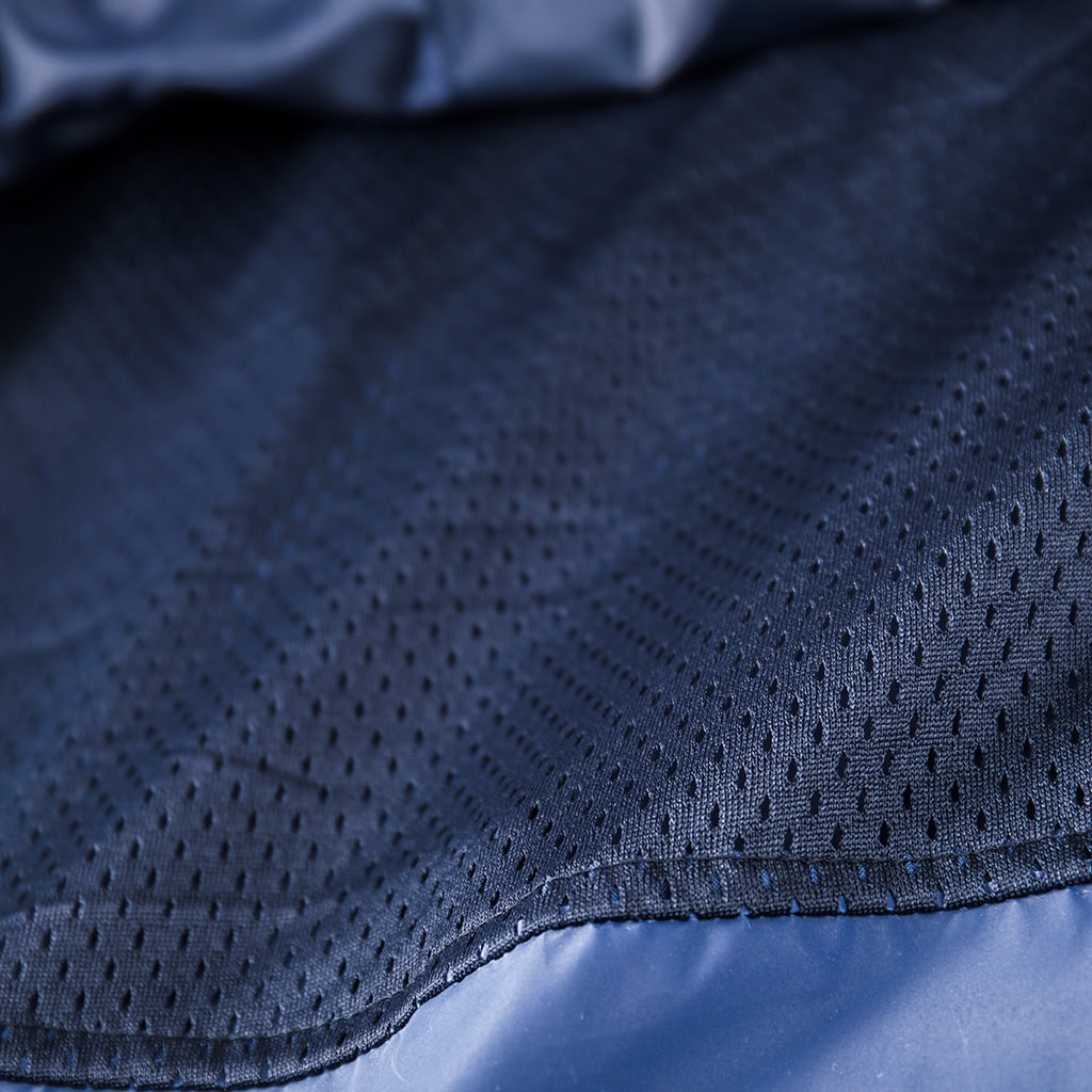 Close-up of the breathable mesh lining inside the custom navy blue waterproof long raincoat.