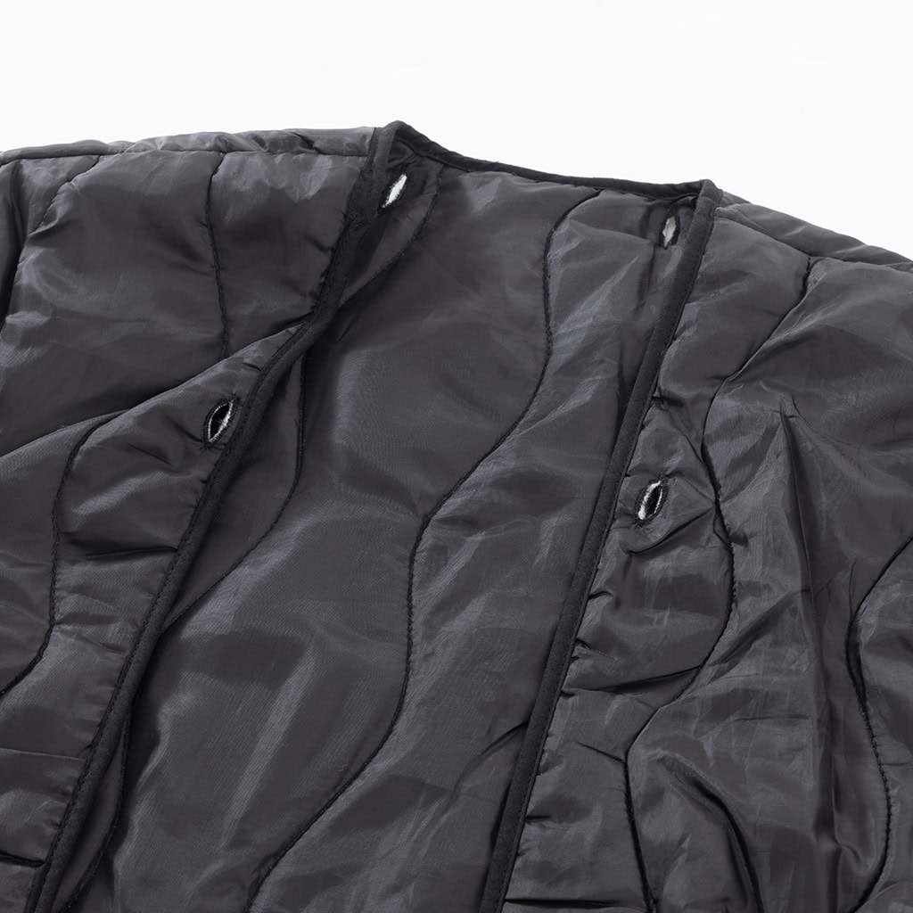 Full view of the lightweight, removable quilted liner for the custom midnight blue camo M65 jacket.