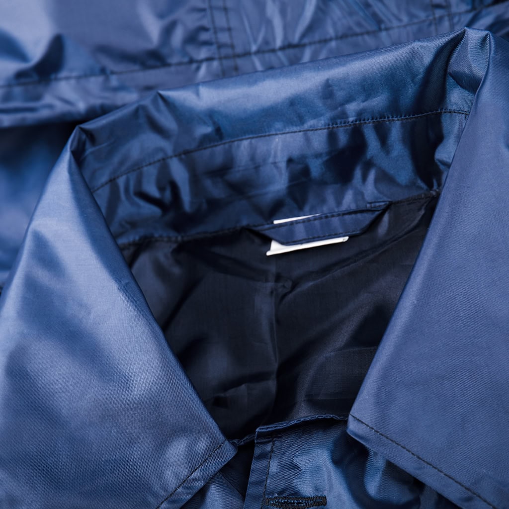 Close-up of the wide lapel collar and detachable hood on the custom navy blue waterproof long raincoat.