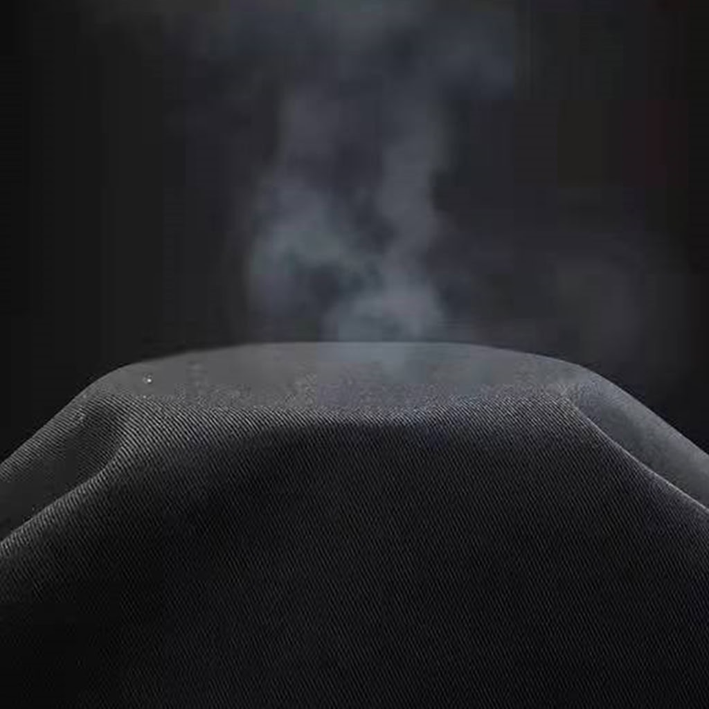 Demonstration of the breathable TC 65/35 rip-stop fabric used for the custom black security guard uniform.